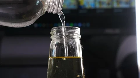 Preparing aroma diffuser liquid with alcohol and essential oil Stockbeeldmateriaal 336557244