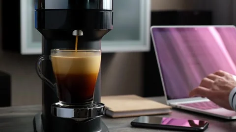 Preparing aromatic coffee in a capsule coffee machine in the morning when s.. Stock Footage 252067463