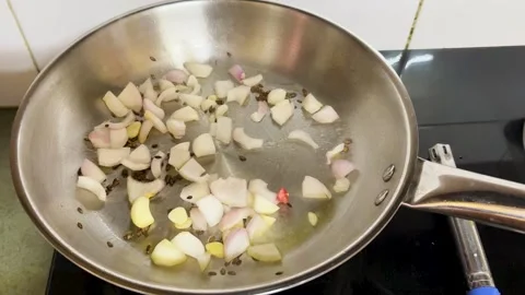 Preparing Aromatic Indian Curry Base With Garlic Onion And Cumin On Stove Stock-Footage 340955727