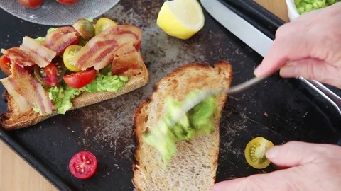 Preparing an avocado, bacon and tomato sandwich Stock-Footage 93790529