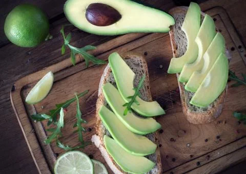 Preparing avocado sandwich in the kitchen 库存照片