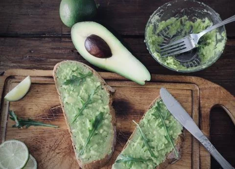 Preparing avocado sandwich in the kitchen Stock Photos