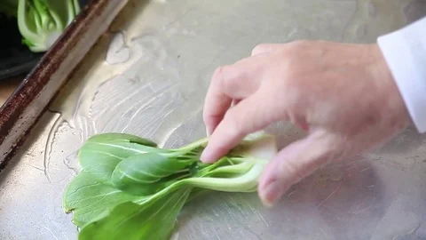 Preparing baby bok choy for roasting Stock Footage 81748596