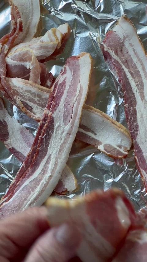 Preparing bacon slices to cook in oven Stock Footage 242374272