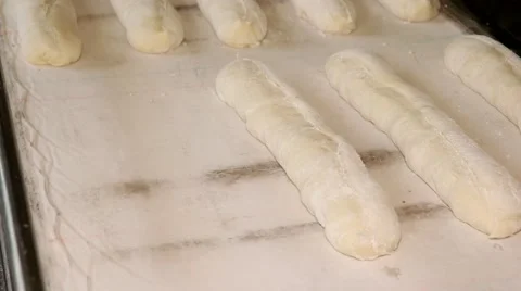 Preparing the baguettes dough before placing in hot oven Stock-Footage 64470655