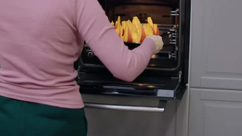 Preparing to bake sliced orange pumpkin in oven chopped sweet pumpkin baking Video stock 218791332