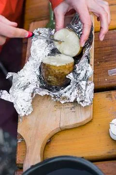Preparing a baked potatoe Stock Photos