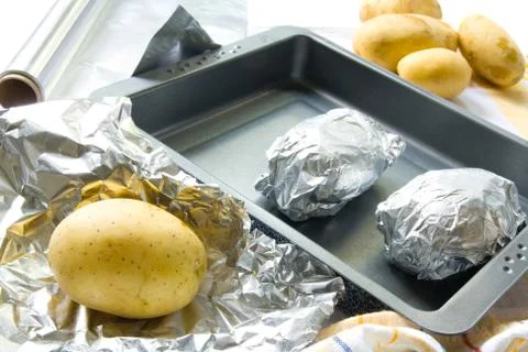 Preparing baked potatoes Stock Photos