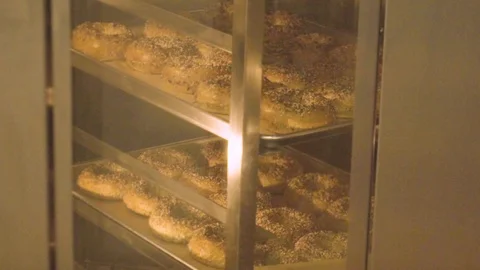 Preparing &amp; Baking Delicious New York Style Bagels In A Cafe Bakery Deli Stock Footage 123674022