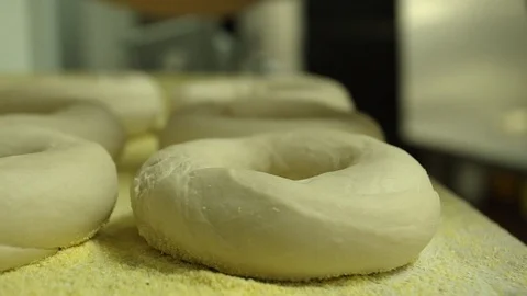 Preparing &amp; Baking Delicious New York Style Bagels In A Cafe Bakery Deli Stock Footage 123674874