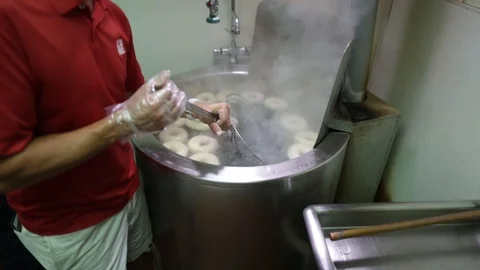 Preparing &amp; Baking Delicious New York Style Bagels In A Cafe Bakery Deli Stock Footage 123878363