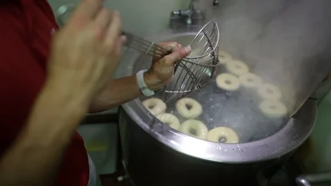 Preparing &amp; Baking Delicious New York Style Bagels In A Cafe Bakery Deli Stock Footage 123878392