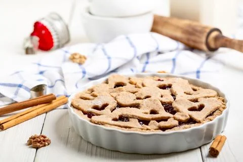 Preparing for baking a pie with cinnamon and berry jam. Stock Photos