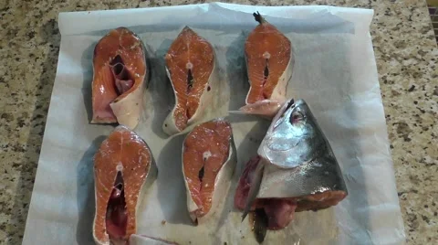 Preparing For Baking Pieces of Red Fish on Dripping Pan Covered Paper For Stock Footage 65264256