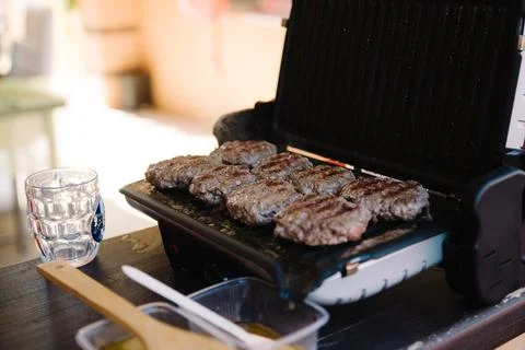 Preparing a batch of ground beef patties on grill or BBQ.home food concept Stock Photos