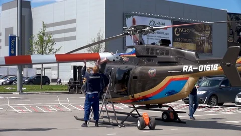 Preparing Bell 407 helicopter to towing. Mechanic remove the rotor blades. Stock Footage 106370248