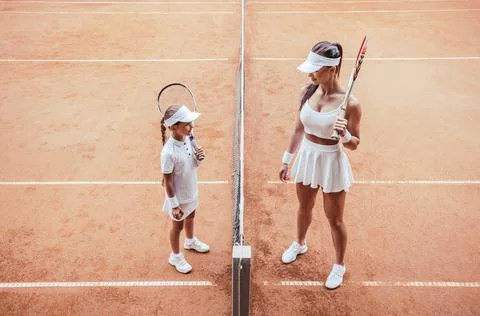 Preparing to big game! Full length top view of a smiling female tennis coach  Stock Photos