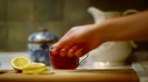 Preparing black tea with lemon Stock Footage 34079931