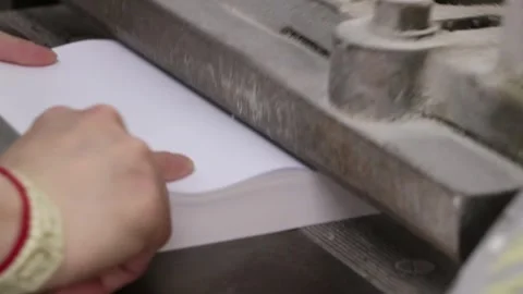 Preparing a book in a printing house for assembly rounding off the end close Stock Footage 300193886