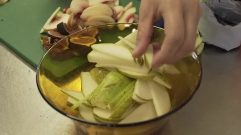 Preparing a bowl of fruit Stock Footage 229579052