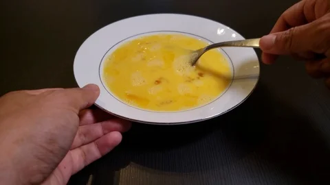 Preparing breakfast by beating eggs using a fork Stock Footage 108967212