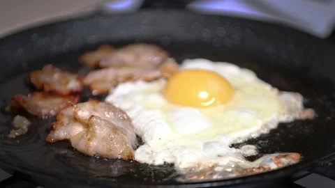 Preparing breakfast. frying bacon close-up slow mo Stock Footage 167819272