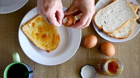 Preparing an breakfast at home, peeling off the egg shell Stock Footage 129176408