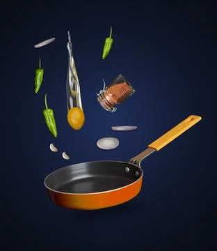 Preparing a breakfast shown via eggs ingredient falling into the frying pan Stock Photos