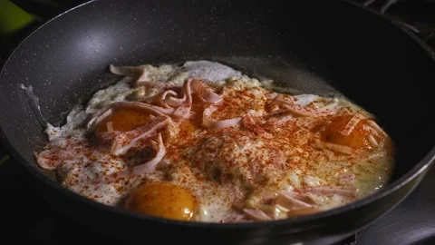Preparing bubbling hot breakfast hand and egg layered tortilla wrap in Stock Footage 167628216