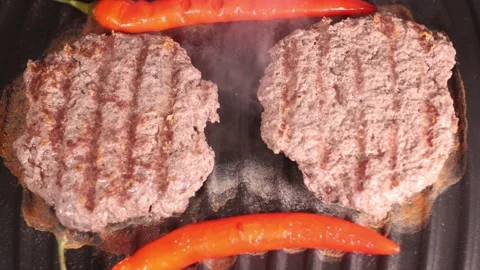 Preparing burgers on electric grill. Stock Footage 145373626