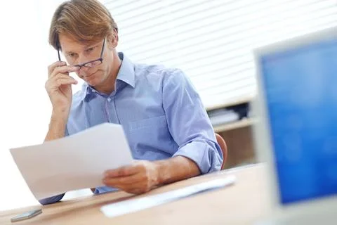Preparing for a business document analysis. Mature, intelligent businessman Stock Photos