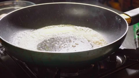 Preparing butter for frying scrambled eggs Stock Footage 98178859