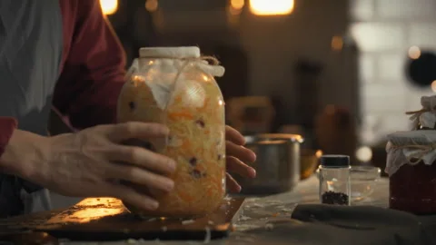 Preparing cabbage for fermentation in a cozy kitchen setting for homemade st 스톡 동영상 331356464