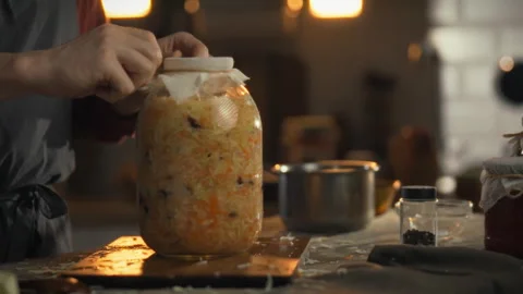 Preparing cabbage for fermentation starter in a cozy kitchen 스톡 동영상 331356639