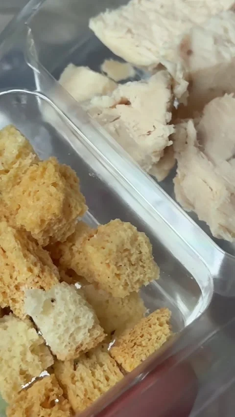 Preparing Caesar salad in a plastic container with all the ingredients on the Stock Footage 323471216