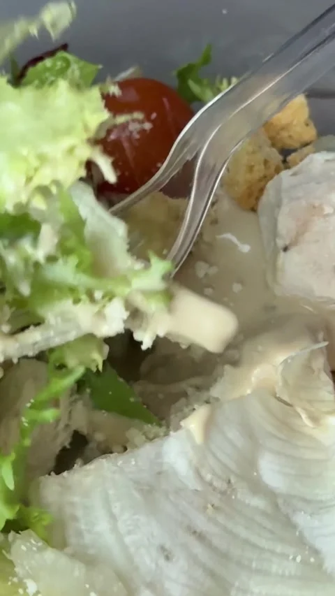 Preparing Caesar salad in a plastic container with all the ingredients on the Stock Footage 323471496
