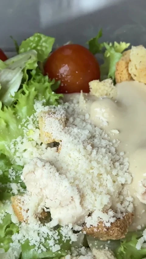 Preparing Caesar salad in a plastic container with all the ingredients on the Stock Footage 323472026