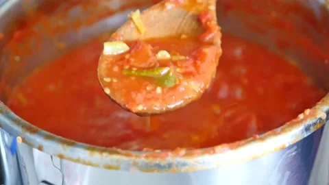 Preparing canned tomato sauce, boiling tomato sauce in a pot, Stock Footage 140097927