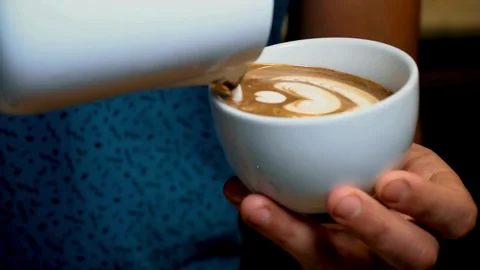 Preparing Cappuccino Coffee. Milk being poured into a mug with coffee. 動画素材 334648131