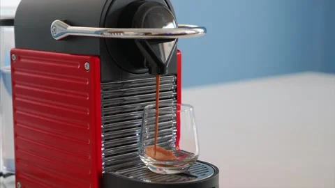 Preparing capsule coffee in red nespresso coffee machine Stock Footage 131090606
