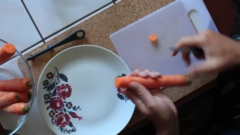 Preparing a carrot for cooking Stock Footage 316486034