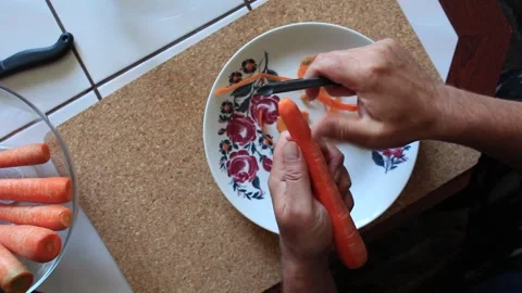 Preparing a carrot for cooking Stock Footage 317142020