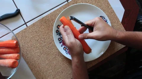 Preparing a carrot for cooking Video stock 317143408