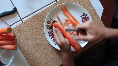 Preparing a carrot for cooking Video stock 317144945