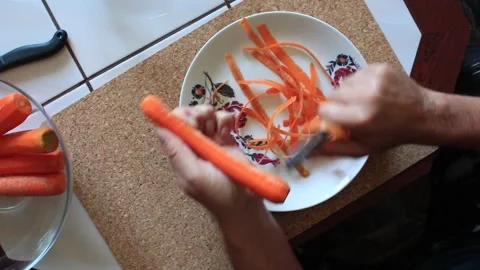 Preparing a carrot for cooking Video stock 317146407