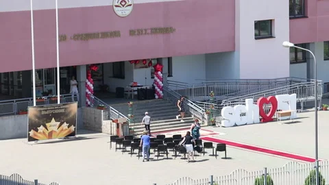 Preparing for the celebration of school graduation. Workers install chairs an Stock Footage 132412754