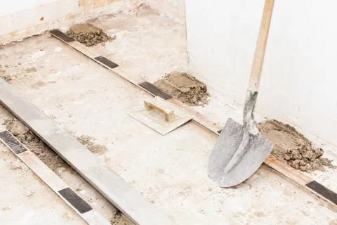 Preparing a cement screed Stock Photos
