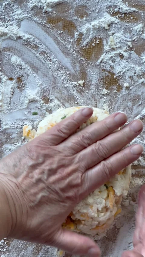 Preparing cheese chive biscuit dough Stock Footage 242513613