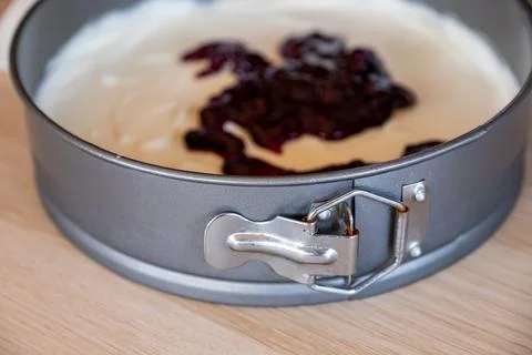Preparing cheesecake with red syrup of red berries and strawberries with ch.. Stock Photos