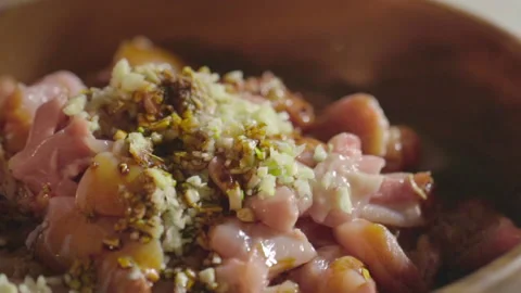 Preparing chicken dish mixture, adding oil Stock Footage 141095479
